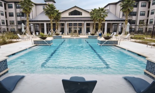 a swimming pool with lounge chairs